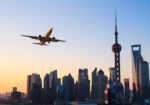 shanghai modern buildings skyline with airplane in sunrise