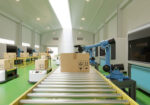 Interior of warehouse in logistic center have AGV/Robot arm,3d rendering